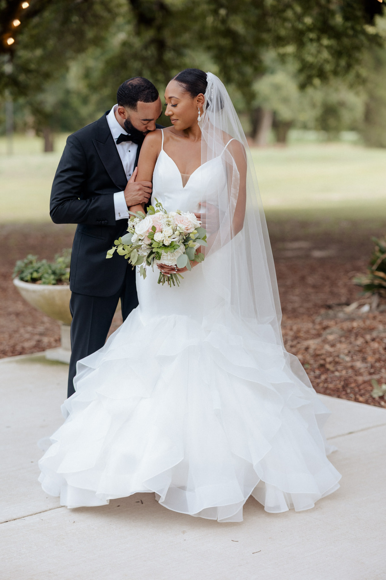 Jerry kissing Takesha's shoulder during their wedding portraits