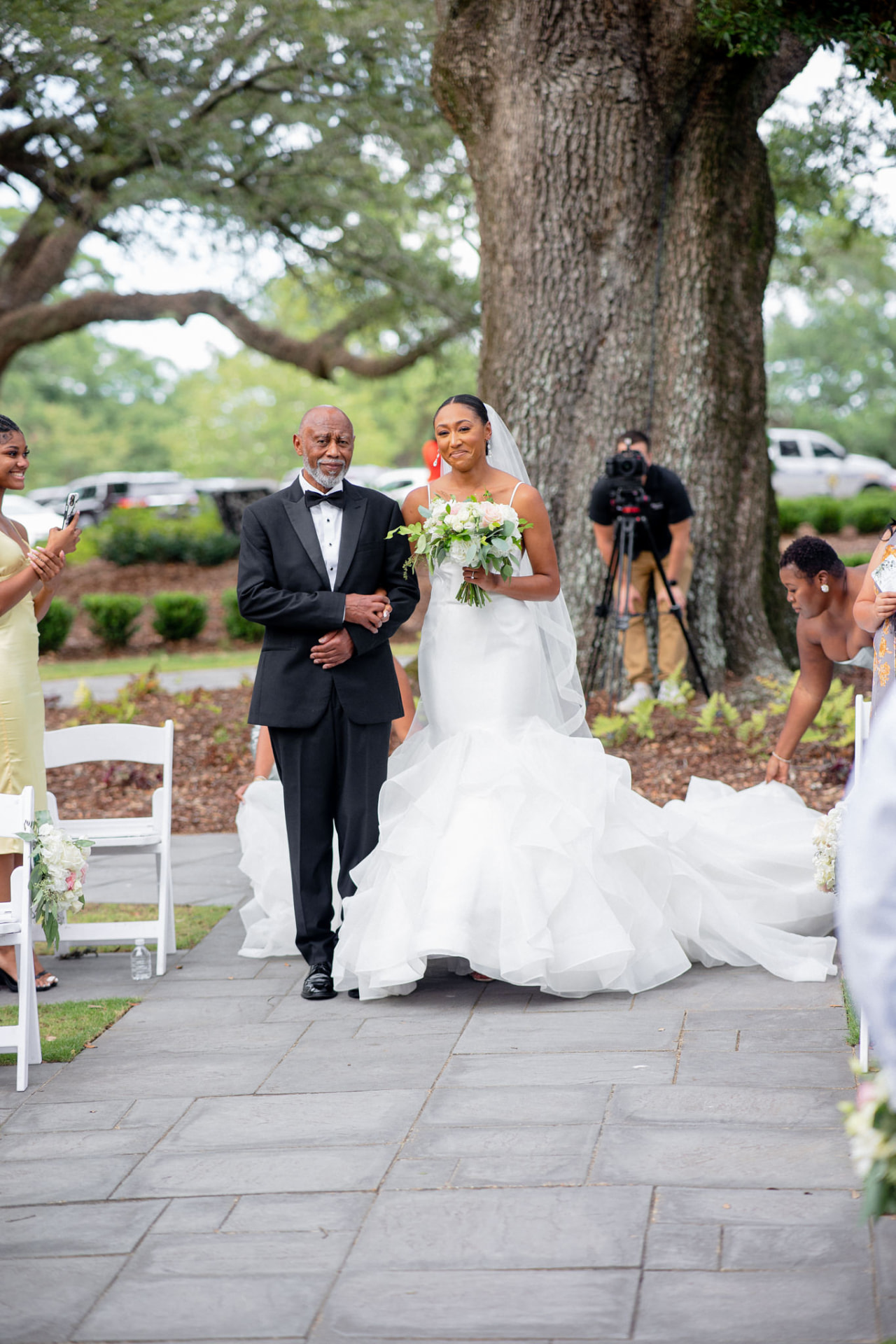 Takesha walking down the aisle with her father